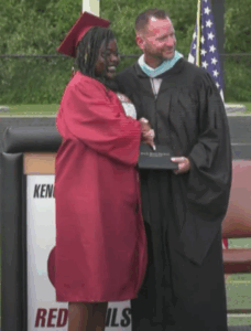 Mr. Kotarak and a student shaking hands at graduation 2025. 