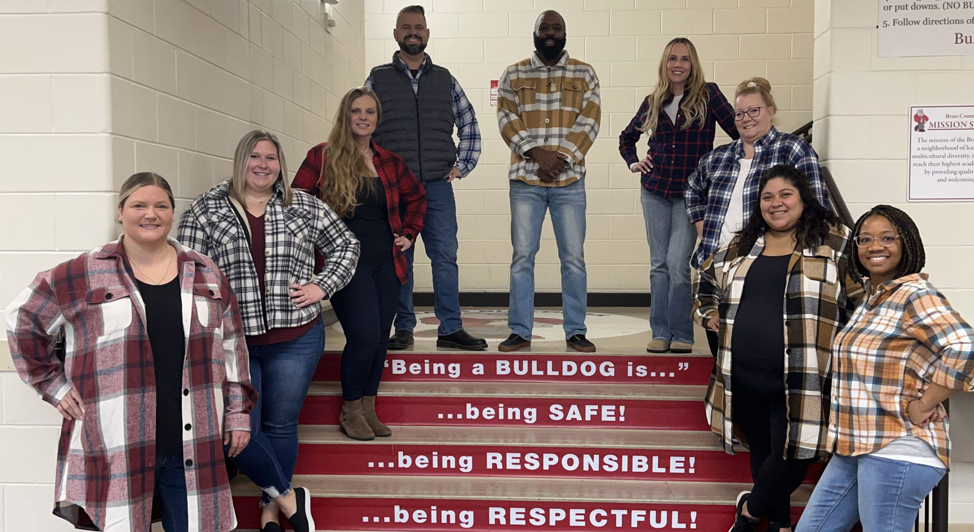 Brass staff members standing as a staircase. The have written on them "Being a Bulldogs is begins safe, being responsible, being respectful."