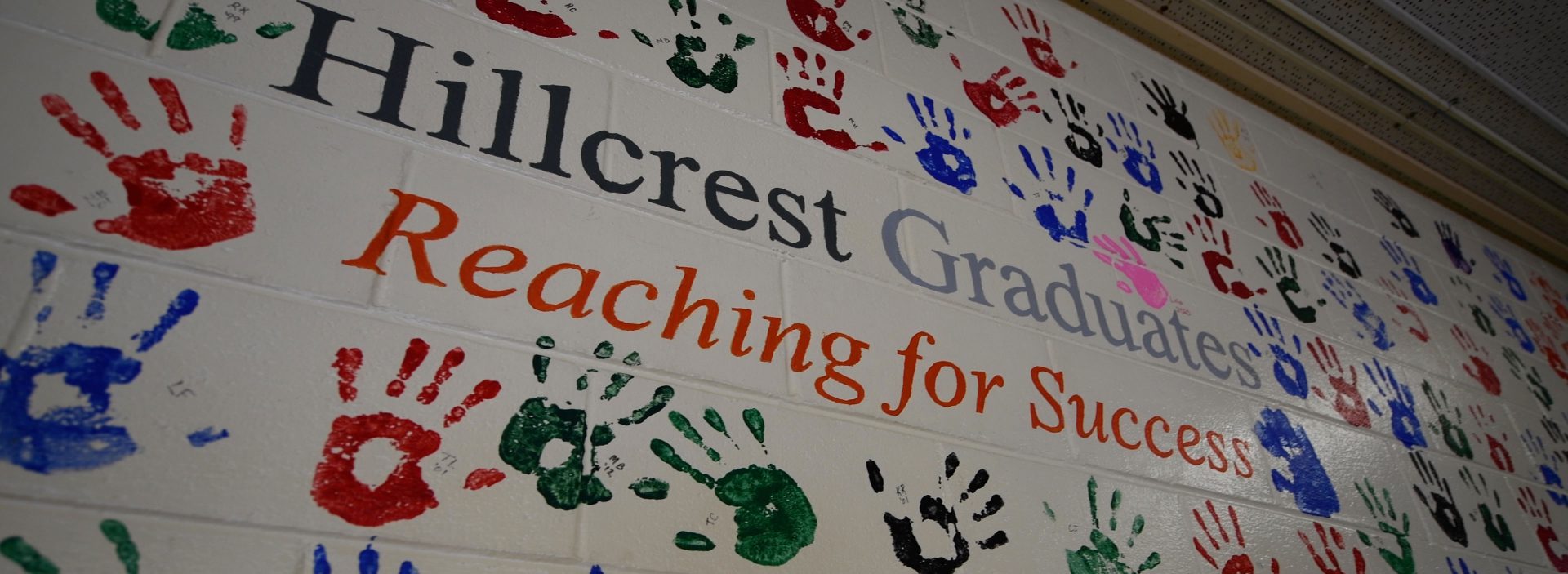 Student handprints on the wall with the message "Hillcrest graduates reading for success."