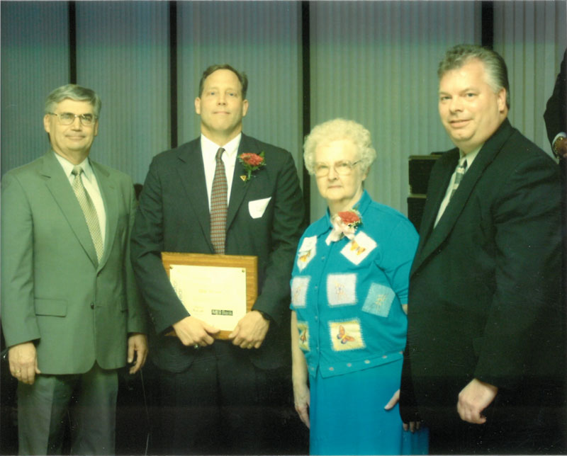 Blane McCann with award presenters.