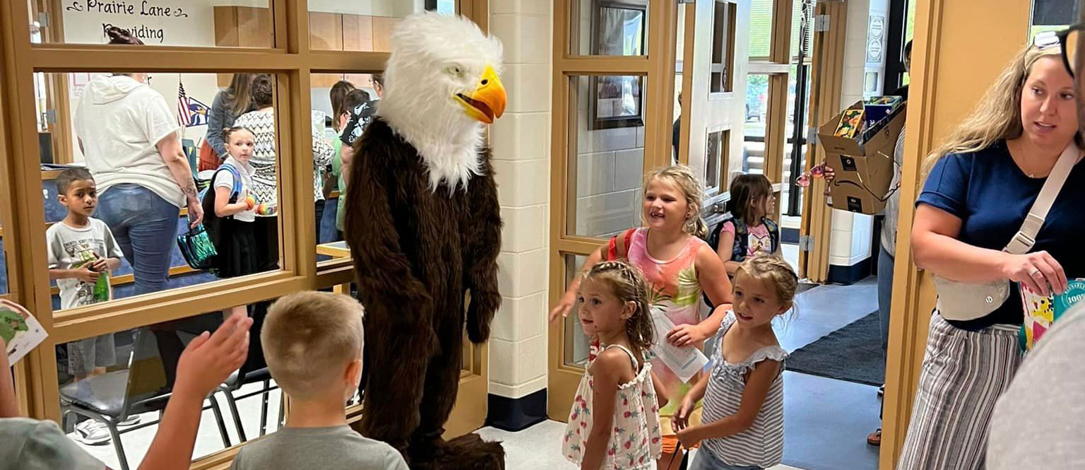 The eagle mascot greets students at the front door.