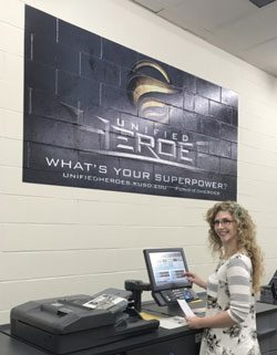 A woman working at a copy center machine.