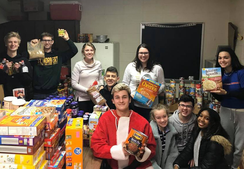 A group of student standing with all the food they collected.