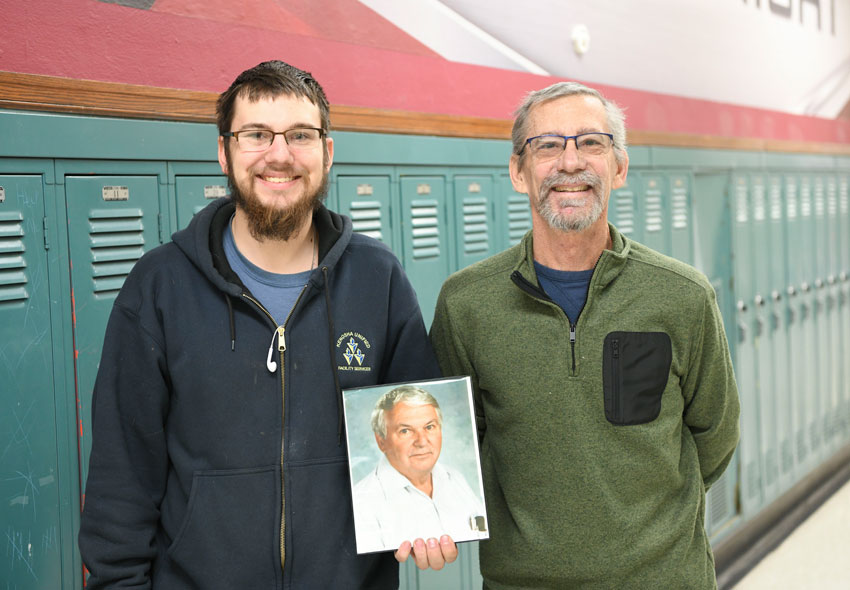 Noah Baas and Tim Baas holding a photo of Donald Baas.