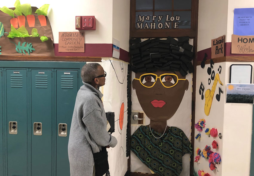 Ardis Mosley looks at a door decorated in honor of Mary Lou Mahone.