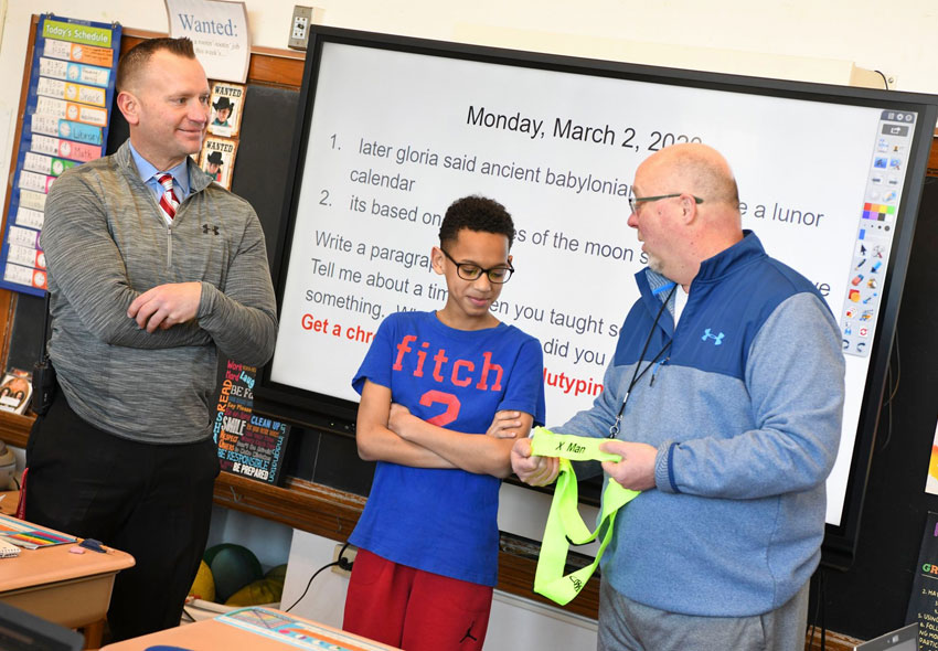 Xavier is awarded the "X-man" award as principal Mr. Kotarak watches.