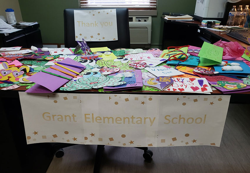 A large pile of Valentine's Day cards on a table.