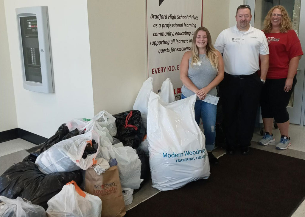 Jeremy Johnson of Modern Woodmen and Allie Kohel are pictured with Michelle Ishmael and a portion of the donation.