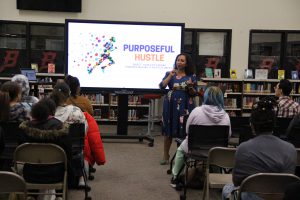 Deanna Singh speaking to a group of students in the library.