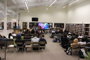 Wide shot of Deanna Singh speaking in the Bradford library.