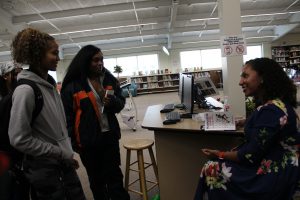 Deanna Singh speaks with two students after her presentation.