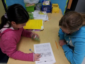 Two girls working on a math game.